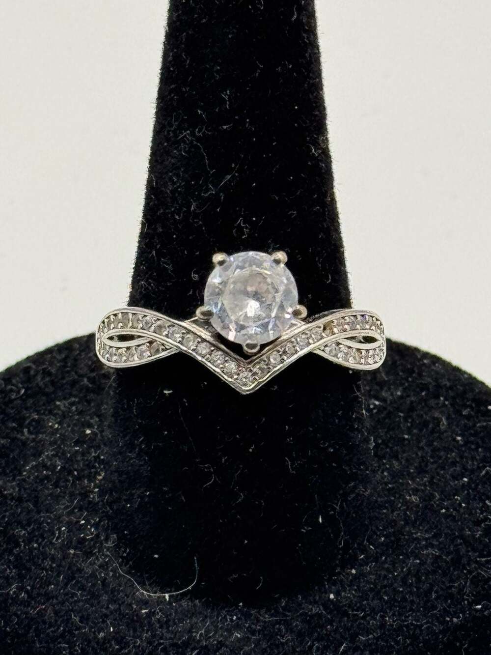 V-Shaped Twist Engagement Ring with Moissanite Round Cut Center Stone and Pavé A